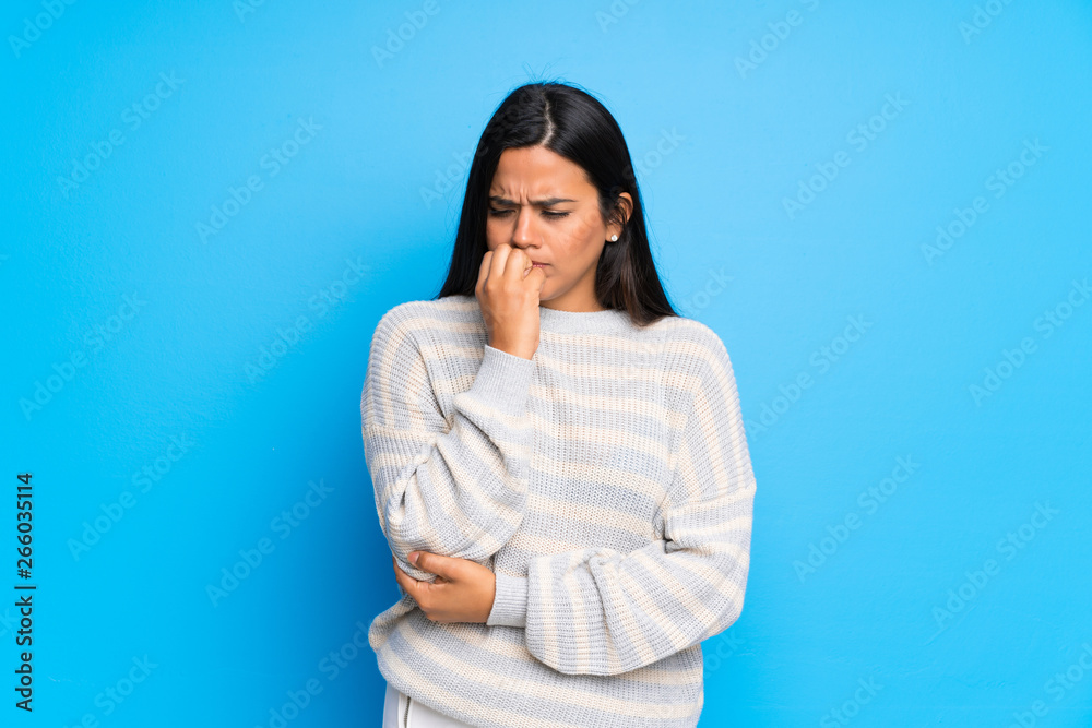 Young Colombian girl with sweater having doubts Young Colombian girl with sweater having doubts