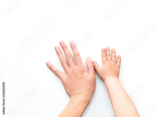 Hands of adult and child. Mother and kid put their palms together on white background. Parent and toddler. Symbol of family, unanimity, support.