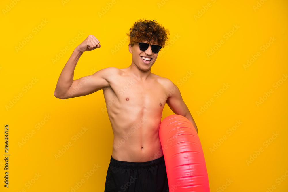 African american man over isolated purple wall celebrating a victory