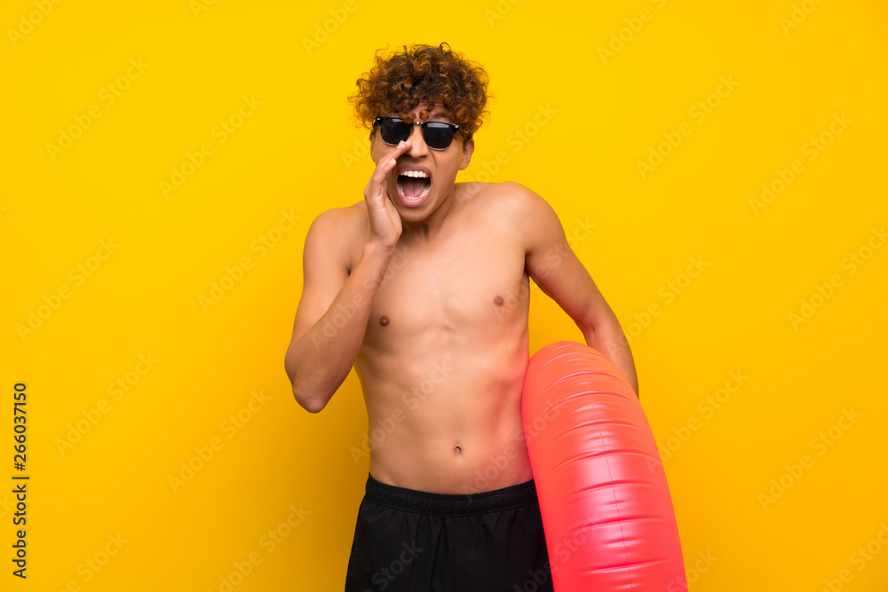 African american man over isolated purple wall shouting with mouth wide open African american man over isolated purple wall shouting with mouth wide open