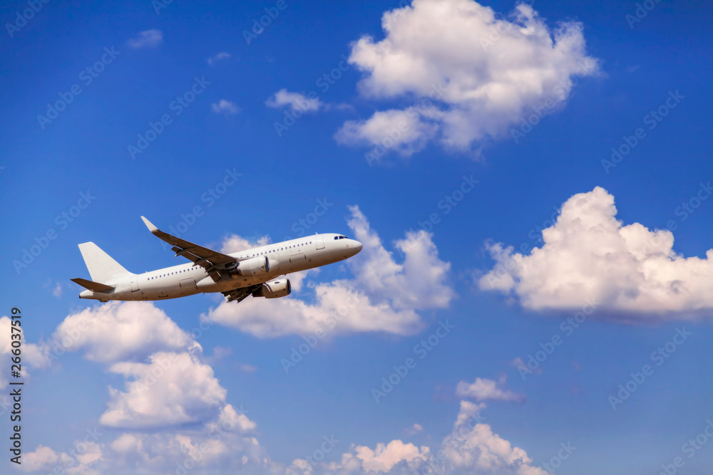 White passenger commercial plane in flight. The aircraft flies airplane a background of clouds. Aircraft side view. - Image White passenger commercial plane in flight. The aircraft flies airplane a background of clouds. Aircraft side view. - Image
