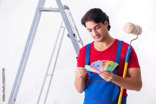 Young handsome contractor working indoors 