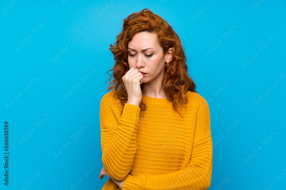 Redhead woman with yellow sweater having doubts Redhead woman with yellow sweater having doubts