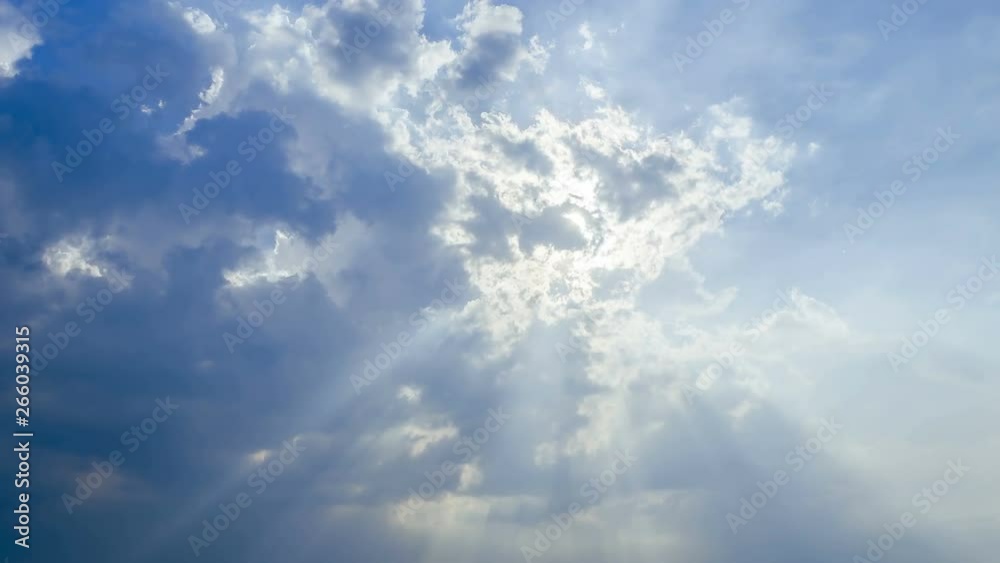 Beautiful cloudscape with large, building clouds and sunrise breaking through cloud mass.