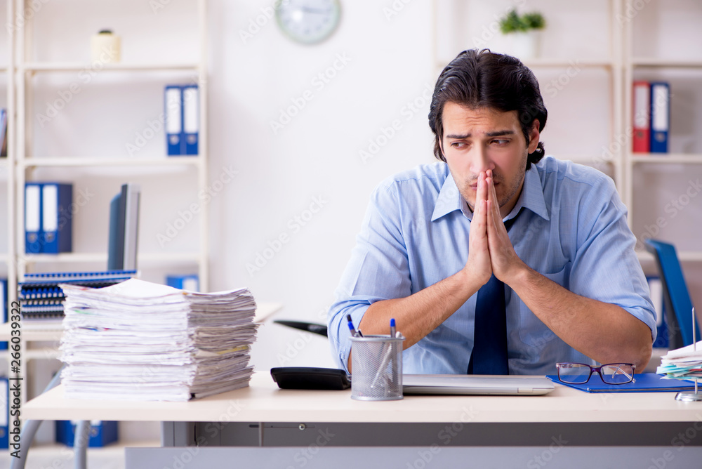 Naklejka premium Young male businessman employee unhappy with excessive work 