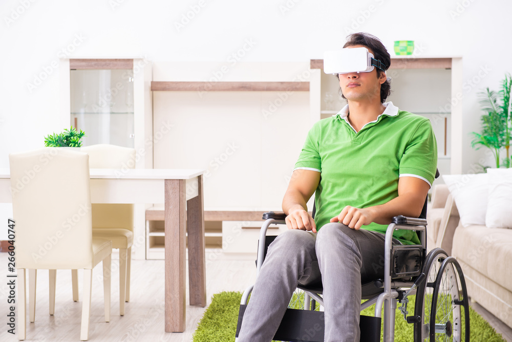 Young handsome man in wheelchair at home Young handsome man in wheelchair at home