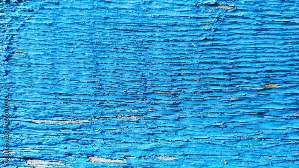 Blue wooden background of cracked surface. Wooden background painted in blue. Abstract rustic pattern