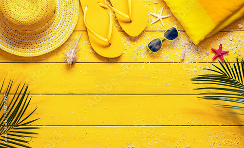 Yellow Summer Background With Beach Accessories And Palm Leaves