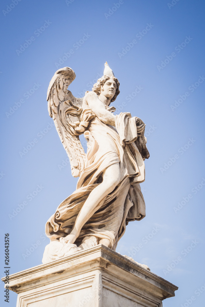 Statue of an angel on the blue sky of Rome