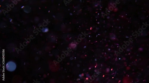 glowing moving red light and bokeh on dark backdrop