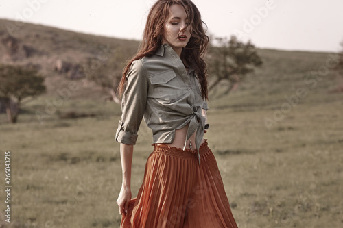 High fashion portrait of young beautiful woman model in stylish trendy clothes. Pretty woman posing outside.
