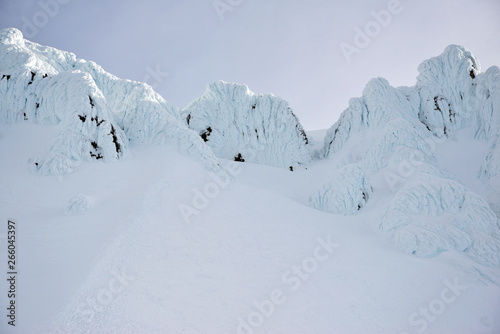 Snow covered terrain on Mount Hood, a volcano in the Cascade Mountains in Oregon popular for hiking, climbing, snowboarding and skiing, despite risks of avalanche, crevasses and weather on the peak. © nyker