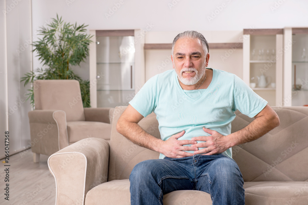 White bearded old man suffering at home White bearded old man suffering at home