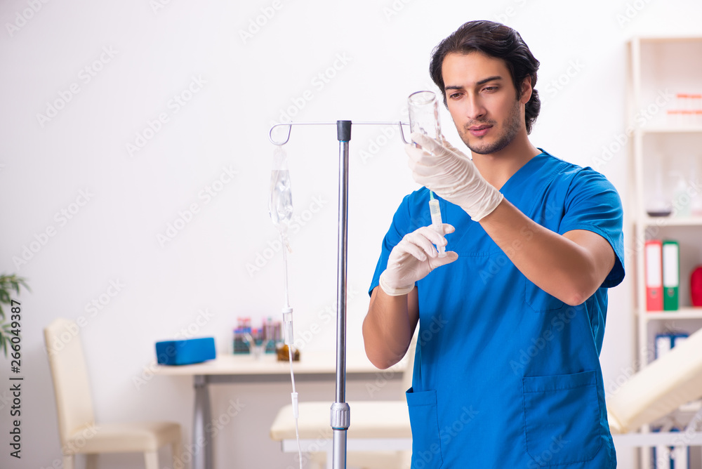 Young male doctor in blood transfusion concept Young male doctor in blood transfusion concept