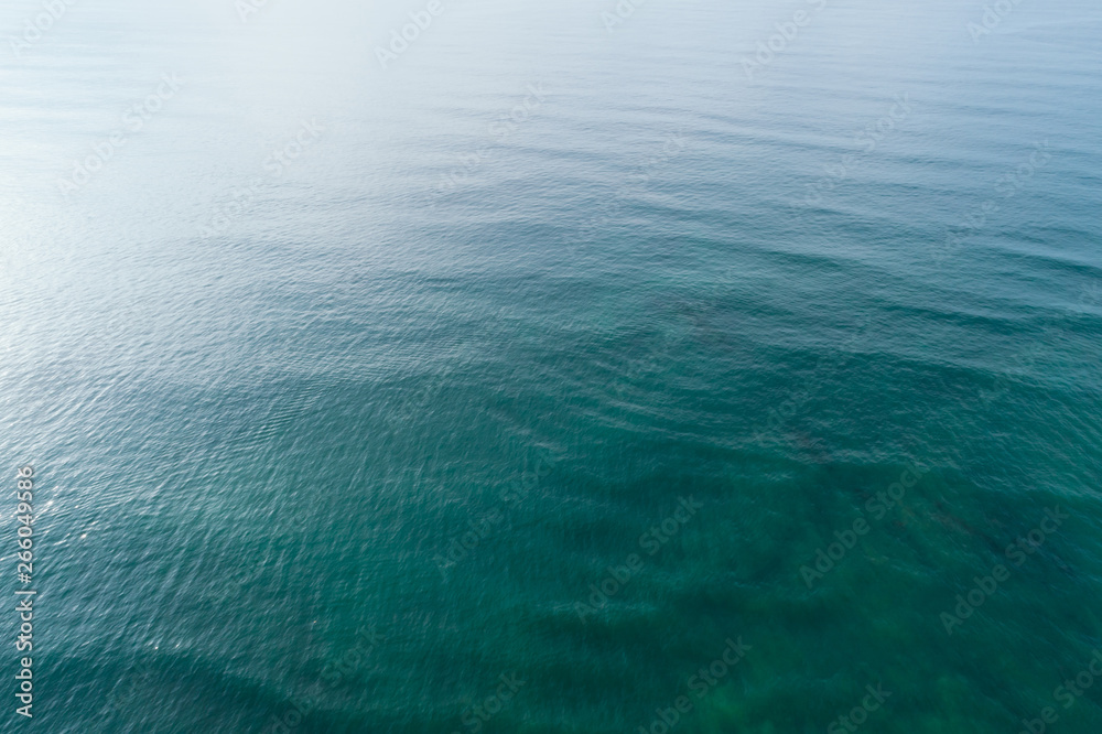 Fototapeta premium Aerial drone view of beautiful sea wave surface in the sunrise
