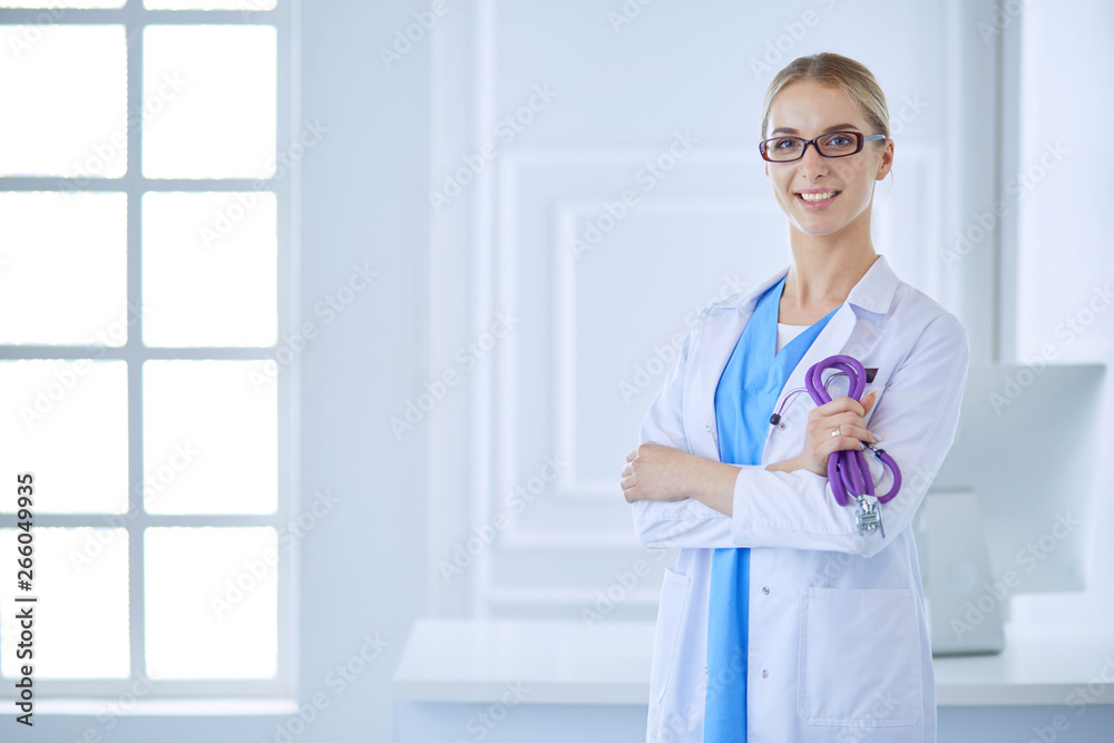 Cheerful happy doctor with crossed hands on blue background Cheerful happy doctor with crossed hands on blue background