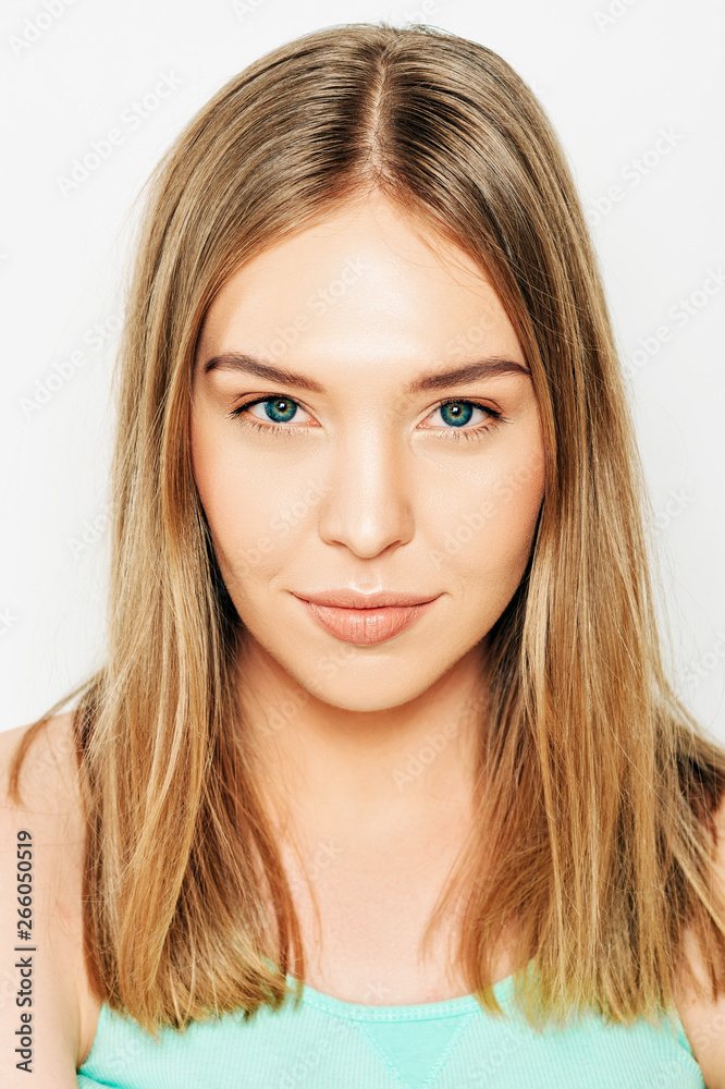 Close up portrait of beautiful young woman with blond hair and nude make up Close up portrait of beautiful young woman with blond hair and nude make up