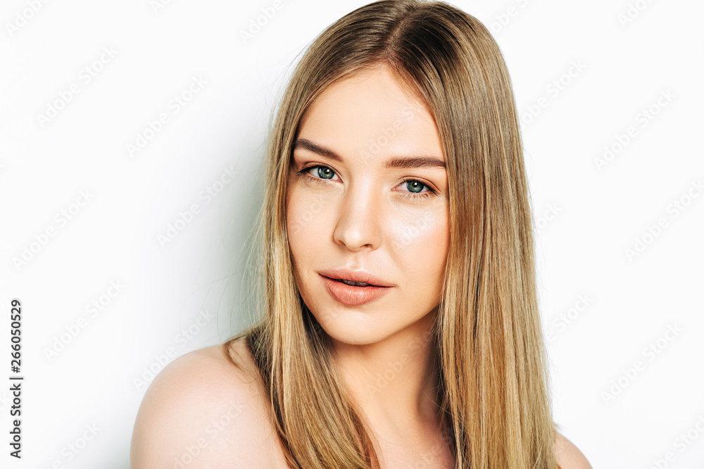 Close up portrait of beautiful young woman with blond hair and nude make up Close up portrait of beautiful young woman with blond hair and nude make up