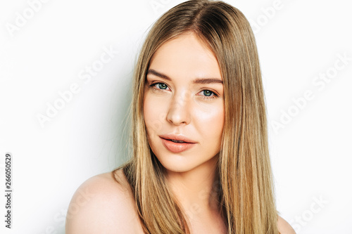 Close up portrait of beautiful young woman with blond hair and nude make up