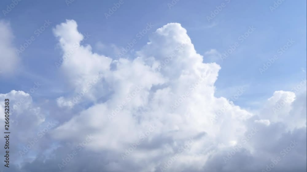 A time lapse of white clouds moving across a blue sky. A time lapse of white clouds moving across a blue sky.