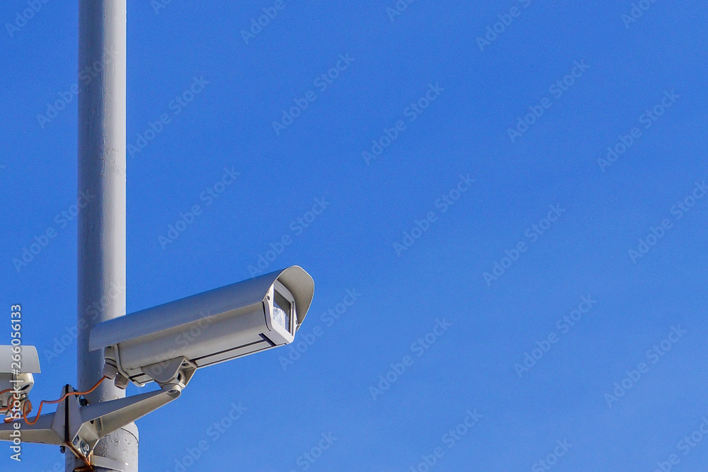 Security camera against the blue sky are monitoring.
