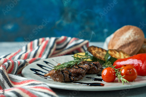 grilled beef steak with vegetables on plate