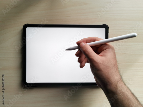 11 inches new pro tablet empty screen with pen and male hands holding it