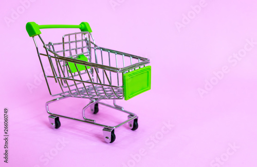 Shopping cart in the supermarket on a purple background