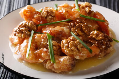 Crispy shrimp tossed in a creamy sweet sauce and candied walnuts close-up. horizontal