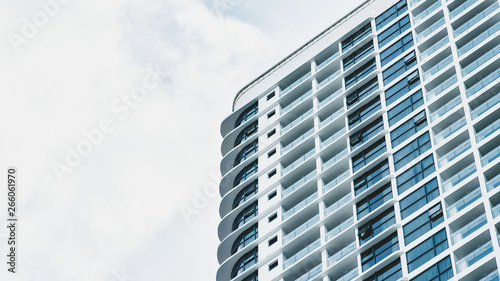 modern high-rise multi-storey hotel building on the background of a beautiful blue cloudy sky. copy space for your text