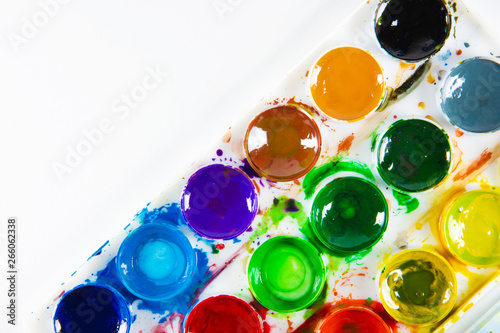 A set of children's paints in circular forms close-up. Copy space for text