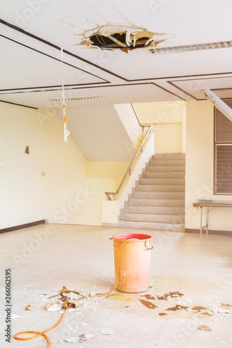 water leak drop in red tank interior office building in from ceiling and flow on terrazzo floor