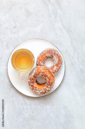 Finnish traditional Vappu food 1st of May, sugar donuts with sima on marble background with copy space