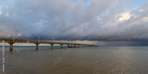 Sea bridge at the Baltic Sea against a dramatic sky with clouds 