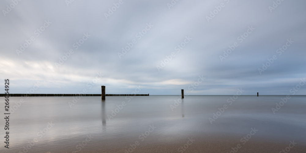 Long exposure at the Baltic Sea against dramatic blue sky Long exposure at the Baltic Sea against dramatic blue sky