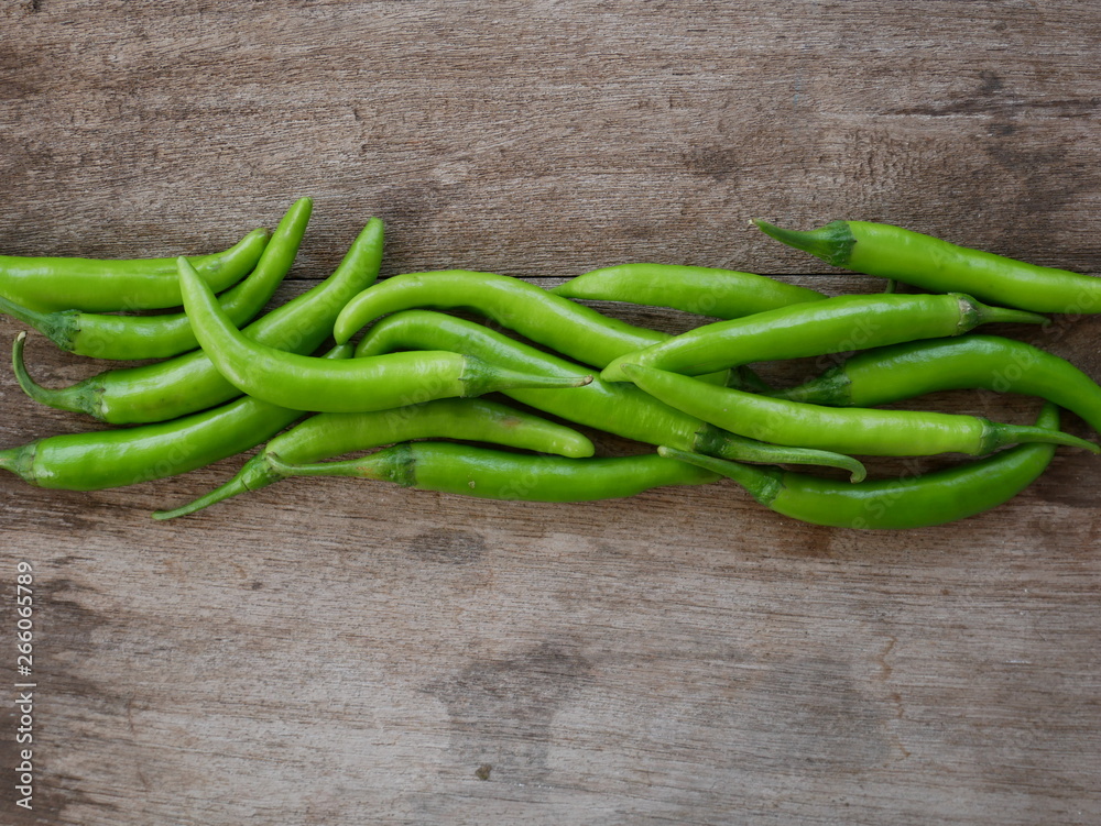 green chili pepper on wood background green chili pepper on wood background