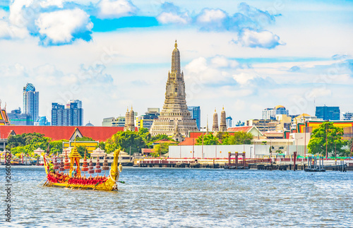 View  of   Wat Arun Ratchawararam Ratchawaramahawihan temple  and The Royal Barge Suphannahong Suphan Swan boat or Suphannahong boat in Chao Phraya river at Bangkok Thailand