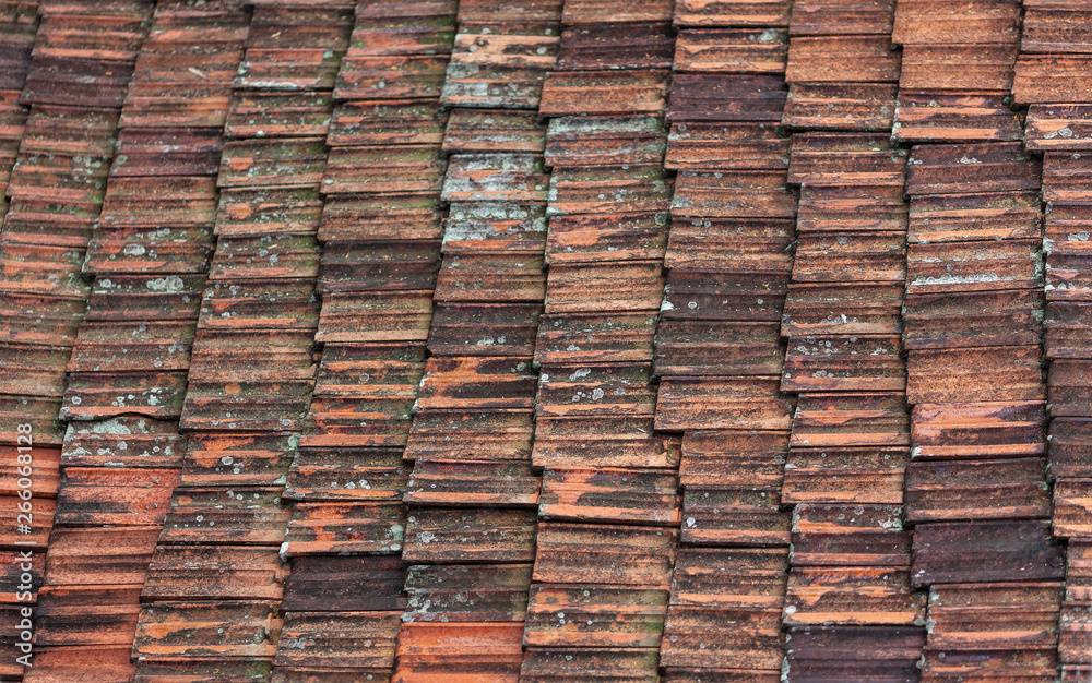 Rows of the old clay tile darkened from time Rows of the old clay tile darkened from time