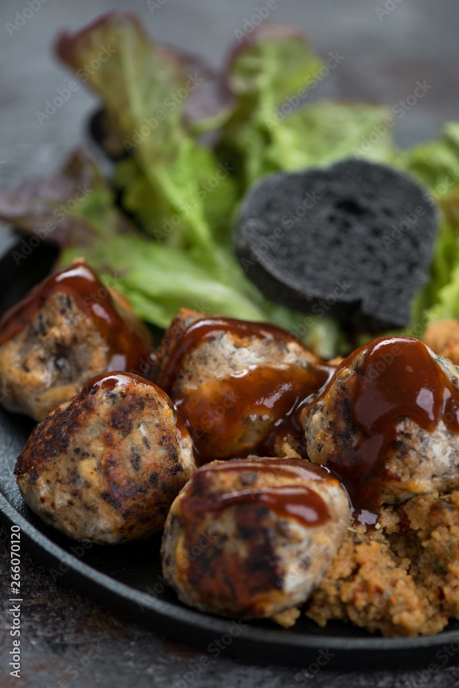 Closeup of roasted truffles made of mushrooms and cheese, selective focus, vertical shot Closeup of roasted truffles made of mushrooms and cheese, selective focus, vertical shot