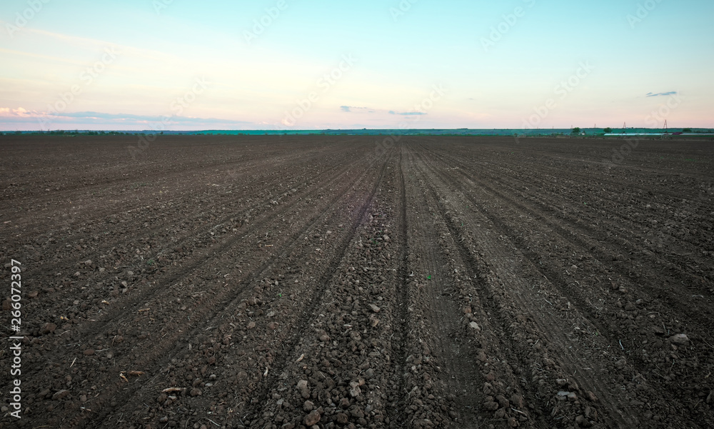 Preparing field for planting. Plowed soil in spring time with blue sky. Preparing field for planting. Plowed soil in spring time with blue sky.