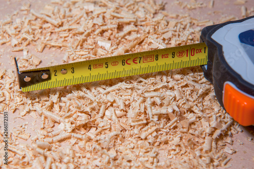 Bild auf Leinwand Table with Tape measure and wood sawdust shavings
