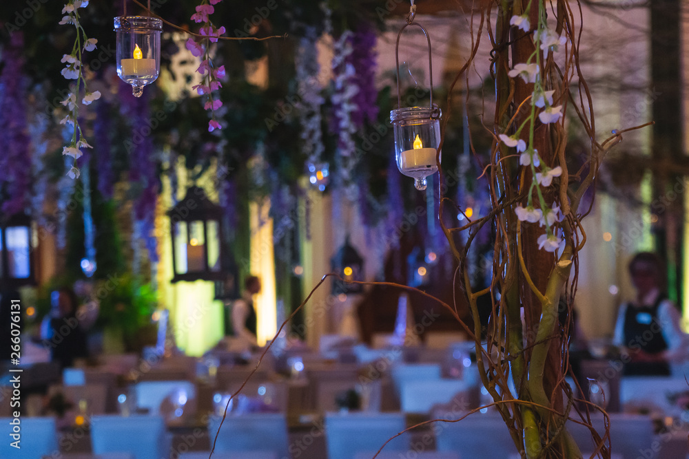 Naklejka premium Vines with Hanging Lanterns Floating over an Elegant Dinner event.