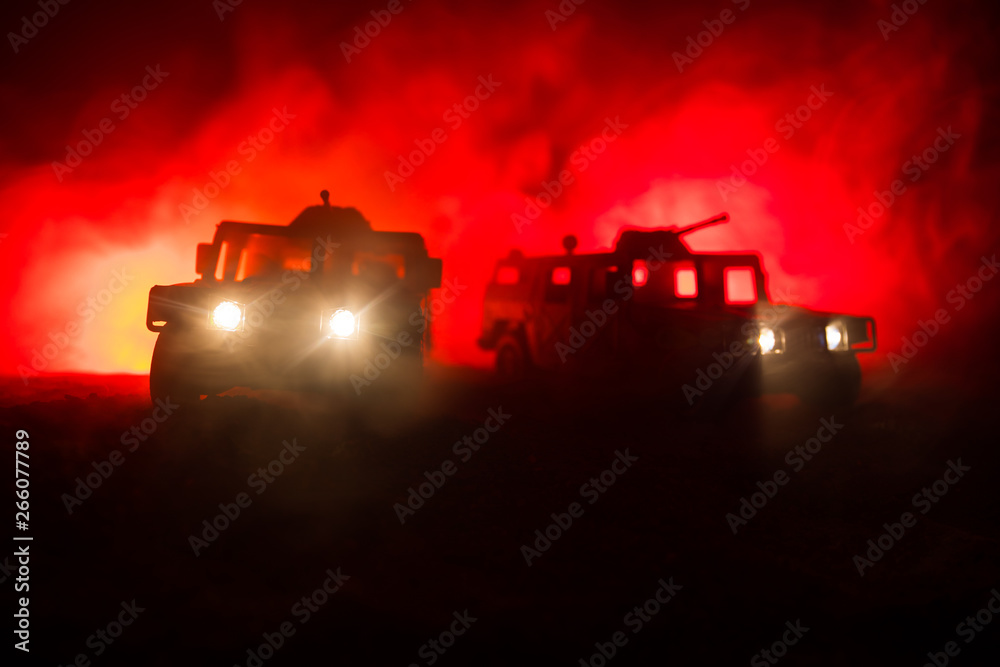 Fototapeta premium War Concept. Military silhouettes fighting scene on war fog sky background, Fighting silhouettes Below Cloudy Skyline At night. Battle scene. Army vehicle with soldiers. army