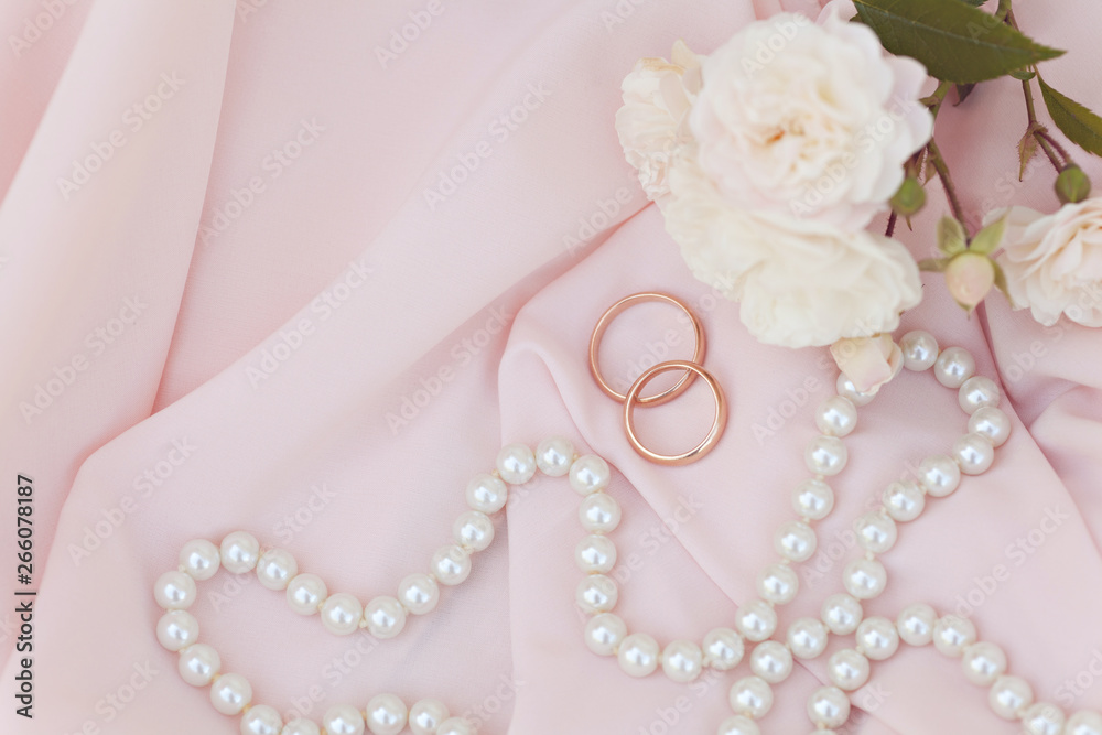Wedding rings on a pink silk background Wedding rings on a pink silk background