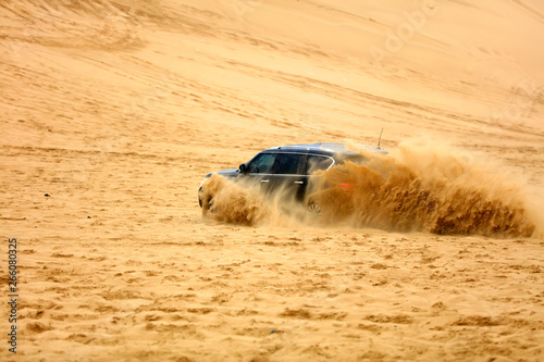An suv was driving in the desert. © zhengzaishanchu
