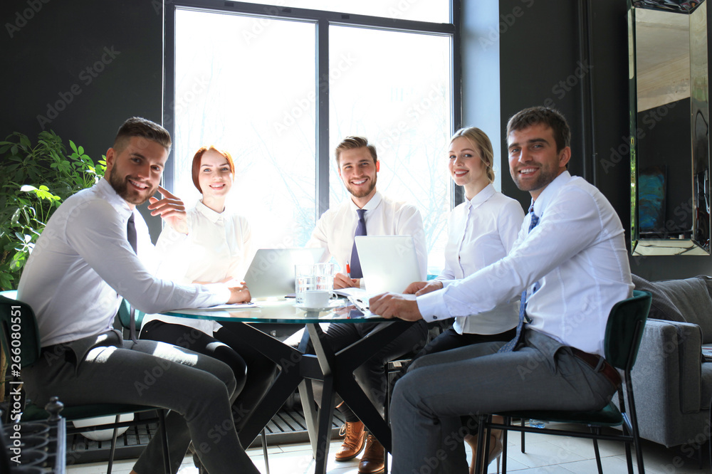 Portrait of a positive business employees at an office business meeting. Portrait of a positive business employees at an office business meeting.