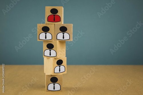 wooden cubes in the form of bosses and subordinates, personnel subordination on a blue background