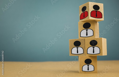 wooden cubes in the form of bosses and subordinates, personnel subordination on a blue background