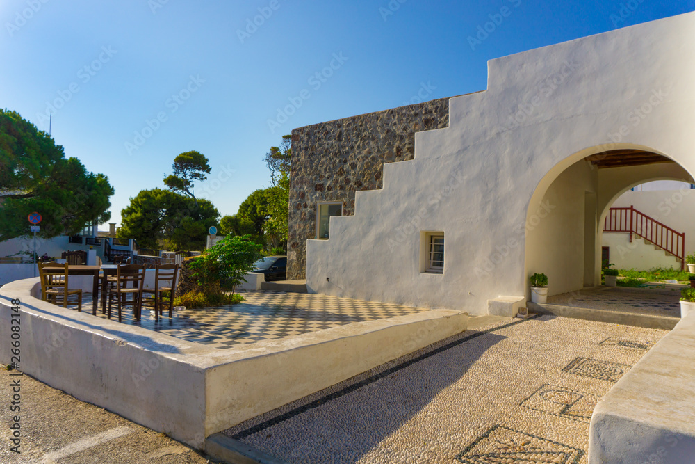 Fototapeta premium Street view of Plaka picturesque village with paved alleys and traditional houses in Milos island in Cyclades, Greece