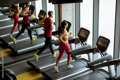 Couple run on treadmills in...